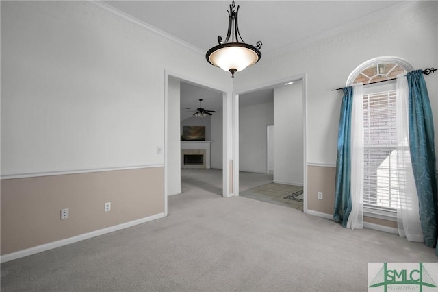 unfurnished room featuring crown molding, light carpet, and ceiling fan