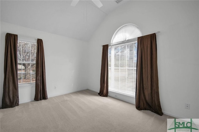 unfurnished room featuring lofted ceiling, light carpet, and ceiling fan