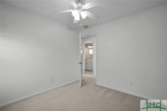 spare room featuring ceiling fan and light carpet