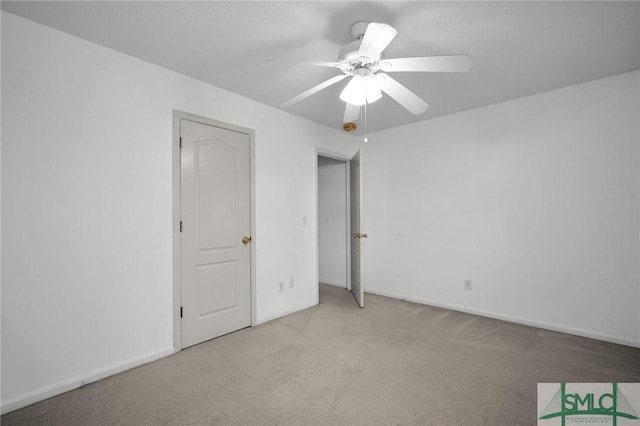 unfurnished bedroom with light colored carpet and ceiling fan