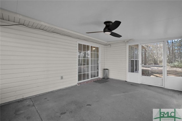 unfurnished sunroom featuring ceiling fan