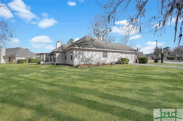 view of home's exterior featuring a garage and a yard