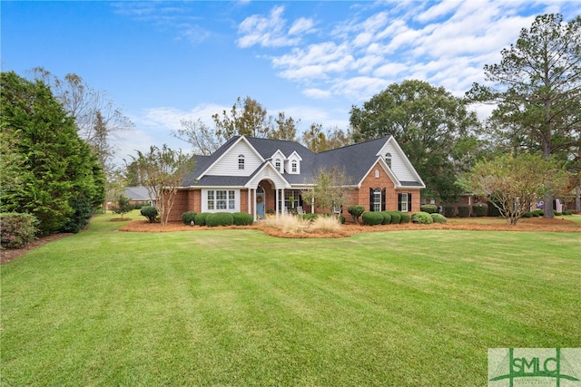 cape cod house featuring a front yard