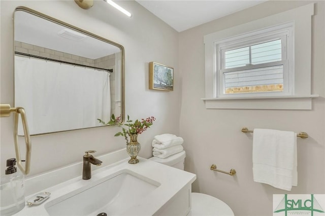 bathroom featuring visible vents, toilet, vanity, and a shower with shower curtain