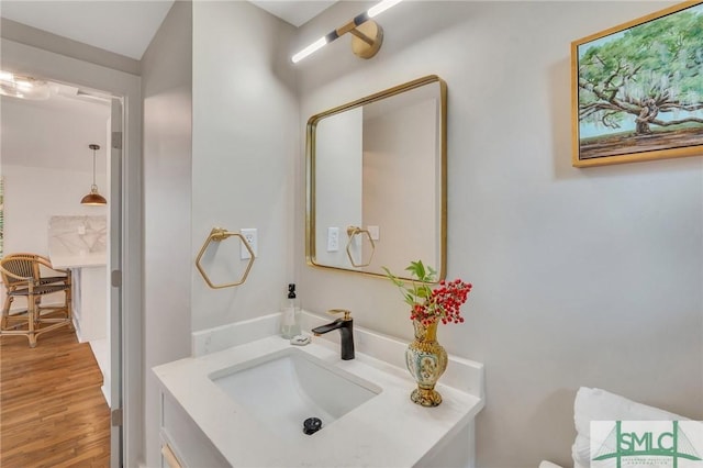 bathroom with vanity and wood finished floors