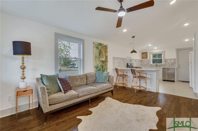 living area with light wood finished floors, recessed lighting, baseboards, and ceiling fan