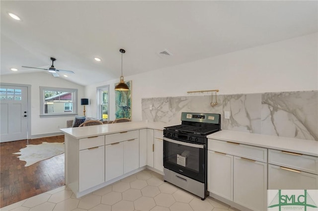 kitchen featuring visible vents, a peninsula, stainless steel gas range, and light countertops