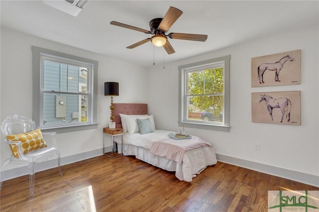 bedroom with wood finished floors, baseboards, and ceiling fan