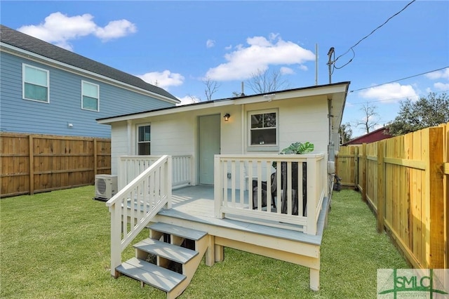 rear view of property featuring ac unit, a fenced backyard, a lawn, and a deck