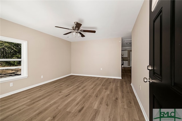 unfurnished room with hardwood / wood-style flooring and ceiling fan