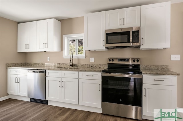 kitchen featuring white cabinetry, appliances with stainless steel finishes, dark hardwood / wood-style flooring, and sink