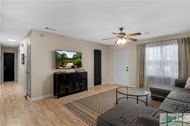 living room featuring ceiling fan and light wood-type flooring