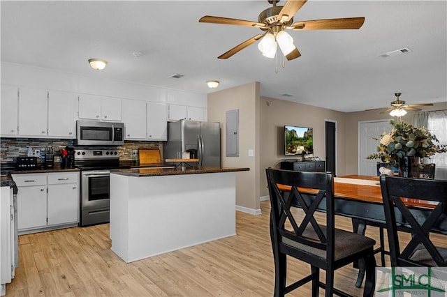 kitchen featuring light hardwood / wood-style flooring, stainless steel appliances, white cabinets, and a kitchen island