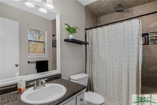 bathroom featuring vanity, toilet, and a shower with shower curtain