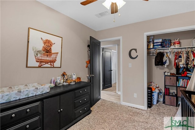 carpeted bedroom with ceiling fan and a closet