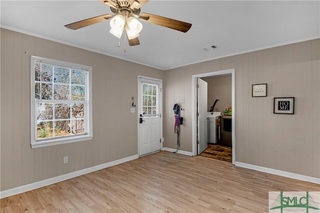 entrance foyer featuring washer / clothes dryer, crown molding, ceiling fan, and light hardwood / wood-style flooring