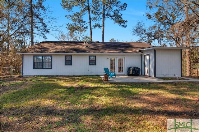 back of house with a patio area, french doors, and a lawn