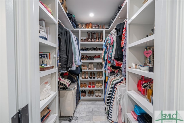 spacious closet with marble finish floor