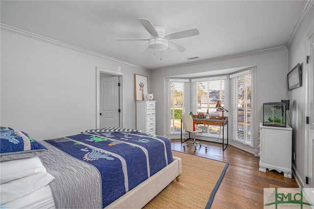 bedroom with ornamental molding, a ceiling fan, visible vents, and wood finished floors