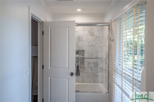 full bath featuring combined bath / shower with glass door and crown molding