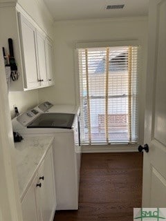 laundry area with cabinet space, plenty of natural light, visible vents, and independent washer and dryer