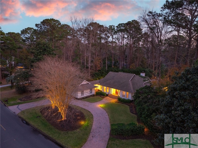 aerial view at dusk with a view of trees