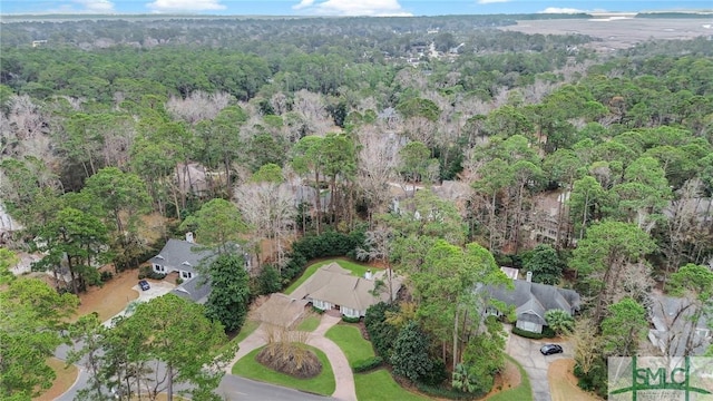 birds eye view of property featuring a view of trees