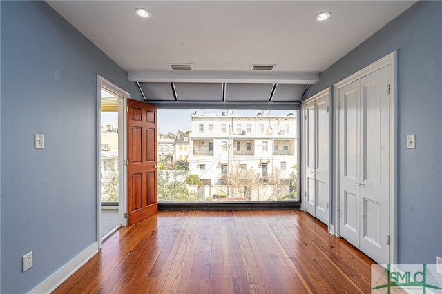 interior space with hardwood / wood-style flooring and two closets