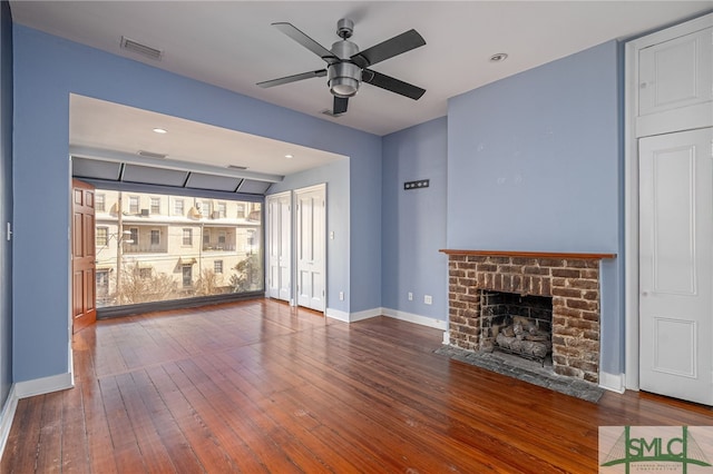 unfurnished living room featuring ceiling fan, wood-type flooring, and a fireplace