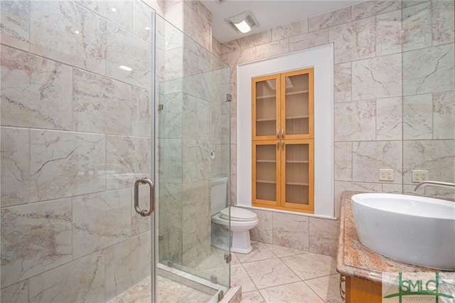 bathroom featuring vanity, tile walls, an enclosed shower, and toilet