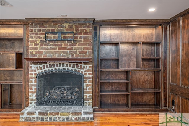 room details with hardwood / wood-style floors and a fireplace