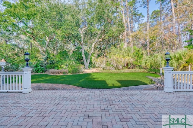 view of home's community featuring a patio area and a lawn