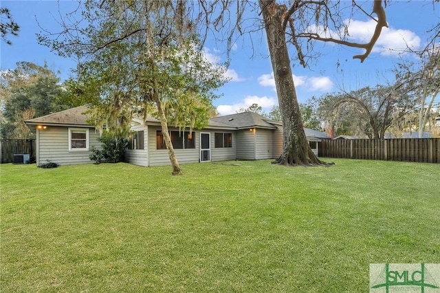 back of property with a yard and cooling unit