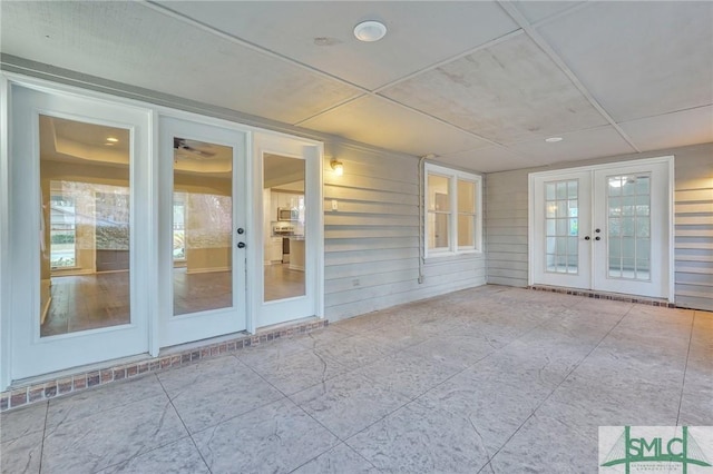 unfurnished sunroom featuring french doors