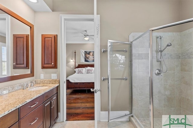 bathroom with tile patterned flooring, vanity, ceiling fan, and a shower with shower door