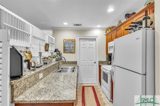 kitchen with sink, crown molding, light tile patterned floors, white appliances, and light stone countertops