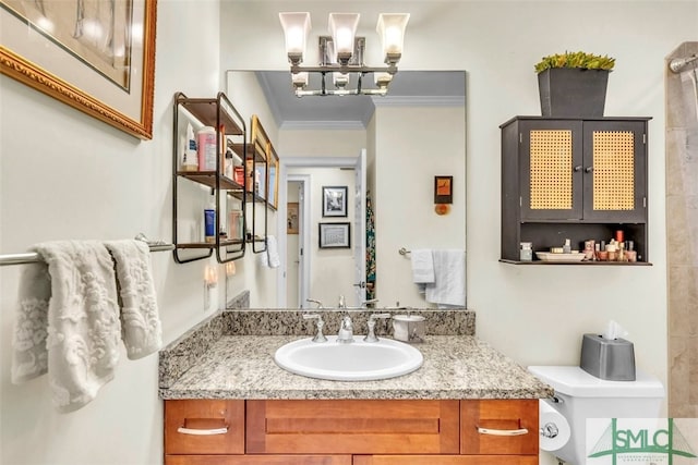 bathroom featuring vanity, crown molding, and toilet