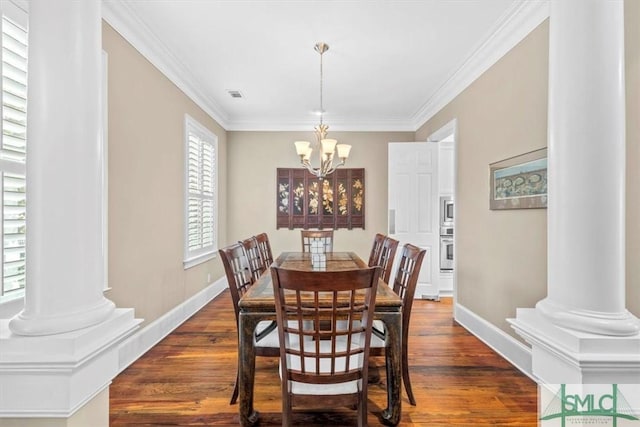 dining area featuring a notable chandelier, dark hardwood / wood-style floors, and ornate columns