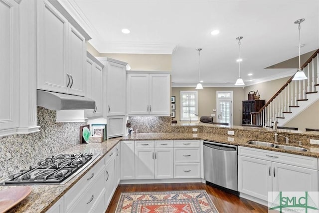 kitchen featuring pendant lighting, sink, stainless steel appliances, white cabinets, and stone countertops