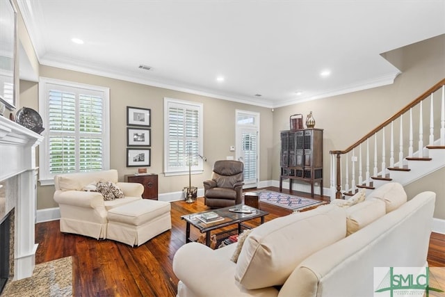 living room with crown molding, a high end fireplace, and dark hardwood / wood-style flooring