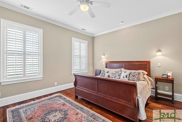 bedroom featuring crown molding, dark hardwood / wood-style floors, and ceiling fan