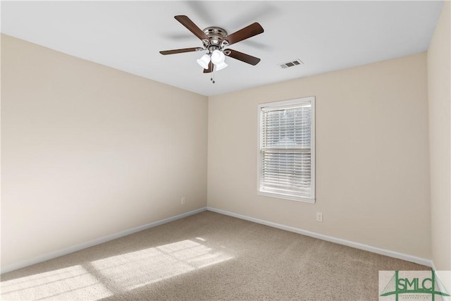 carpeted spare room featuring ceiling fan