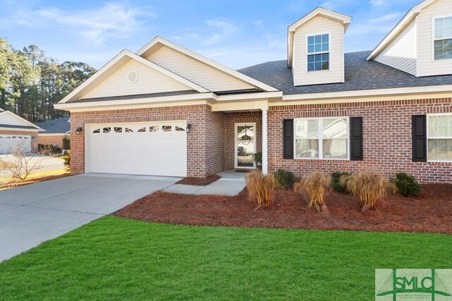 view of front of home with a garage and a front yard