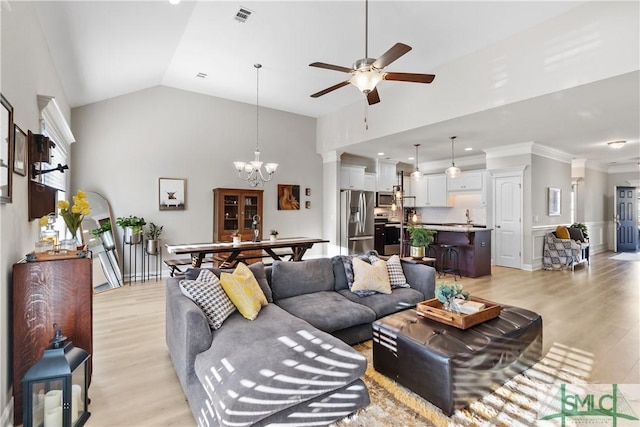 living area featuring light wood-style floors, visible vents, high vaulted ceiling, and ceiling fan with notable chandelier