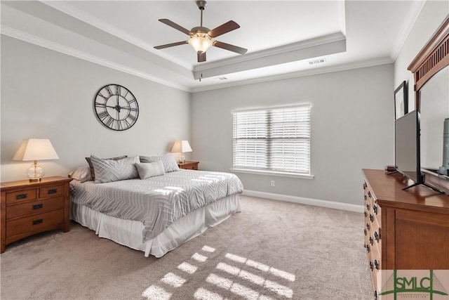 bedroom featuring light carpet, a tray ceiling, visible vents, and baseboards