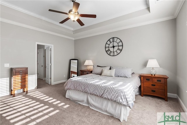 bedroom with light carpet, a tray ceiling, ornamental molding, and baseboards