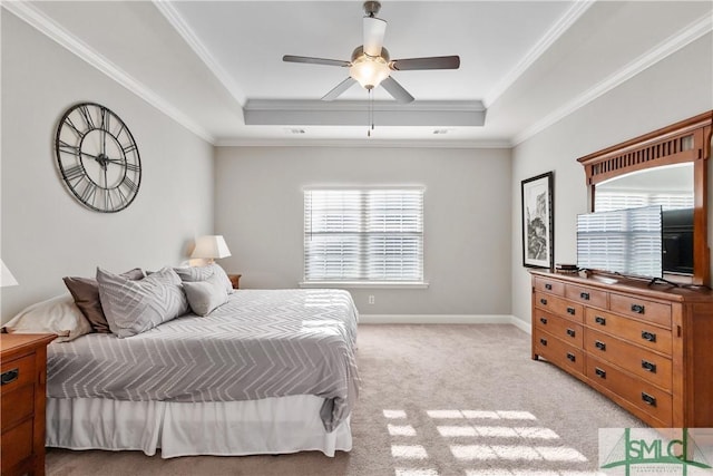 bedroom with a tray ceiling, crown molding, light carpet, ceiling fan, and baseboards