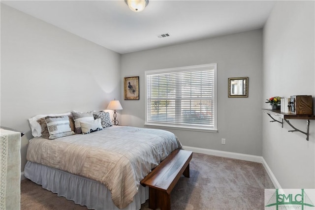 carpeted bedroom with baseboards and visible vents