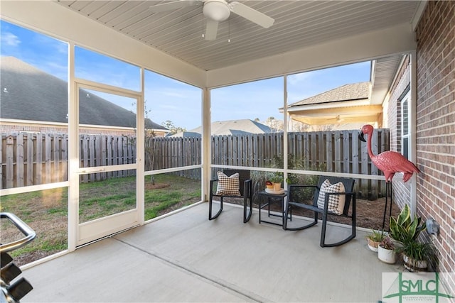 sunroom featuring ceiling fan