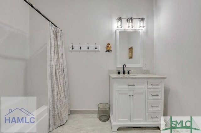 bathroom featuring vanity and shower / bath combination with curtain